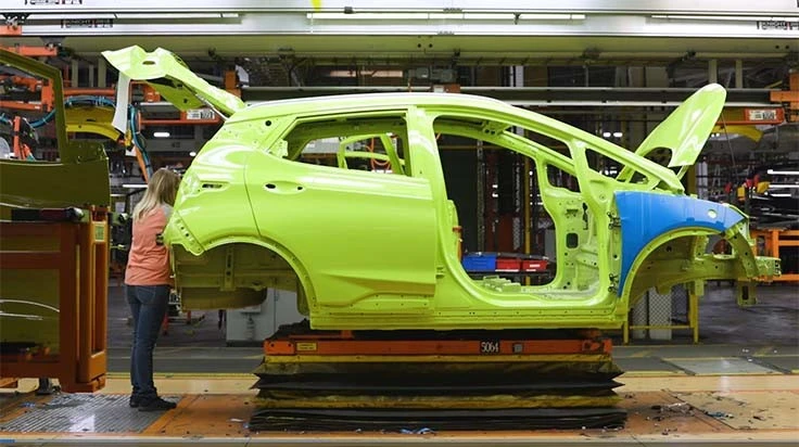 A worker at GM's Lake Orion plant builds a Chevy Bolt EV electric car.