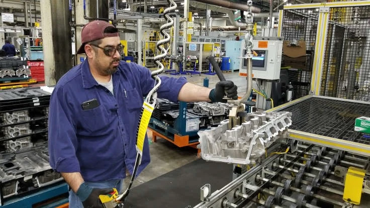 A worker at GM's Defiance Foundry works on engine castings.