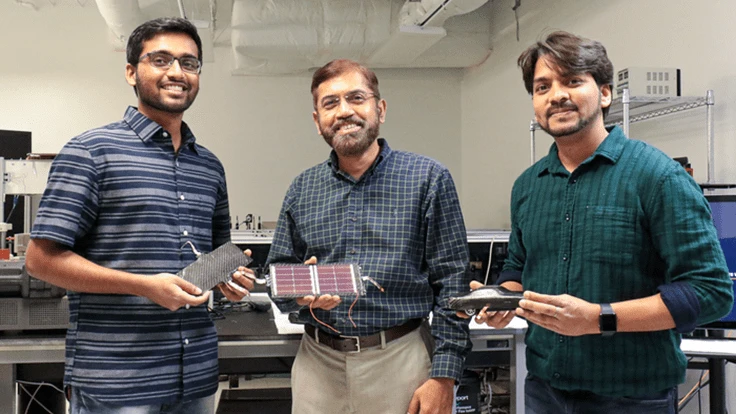RESEARCHERS KOWSIK SAMBATH KUMAR, JAYAN THOMAS, AND DEEPAK PANDEY SHOW THE LIGHTWEIGHT, SUPERCAPACITOR-BATTERY HYBRID COMPOSITE MATERIAL THEY’VE DEVELOPED. KUMAR AND PANDEY ARE UCF DOCTORAL STUDENTS, AND THOMAS IS A PROFESSOR IN UCF’S NANOSCIENCE TECHNOLOGY CENTER AND DEPARTMENT OF MATERIALS SCIENCE AND ENGINEERING.