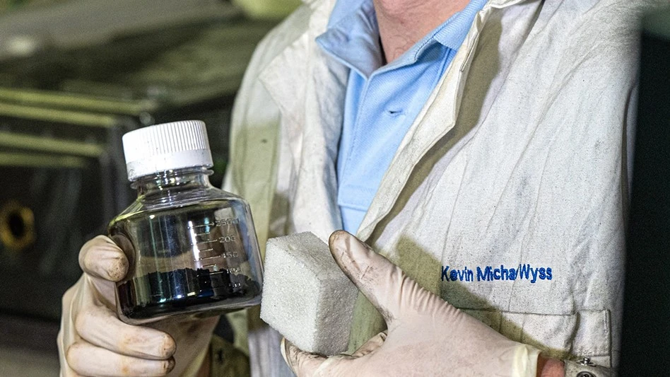 Rice graduate student Kevin Wyss holds a vial of graphene and samples of the graphene-reinforced polyurethane made by the Ford Motor Company.