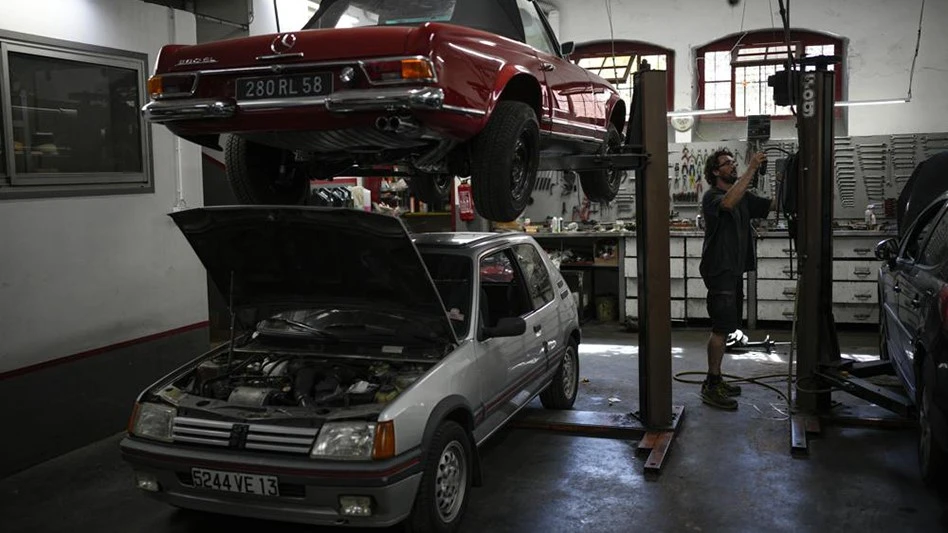Mechanic Frederic Mistre works on a combustion engine car at a garage in Marseille, southern France, Wednesday, June 8, 2022. The European Parliament is voting Wednesday on deeper emission cuts by power plants, factories, planes and cars. The legislative package, which includes a proposed EU ban on combustion-engine cars in 2035, aims to slash Europe's greenhouse gases by 55% in 2030 compared with 1990 levels and put the bloc on a path to climate-neutrality by mid-century.