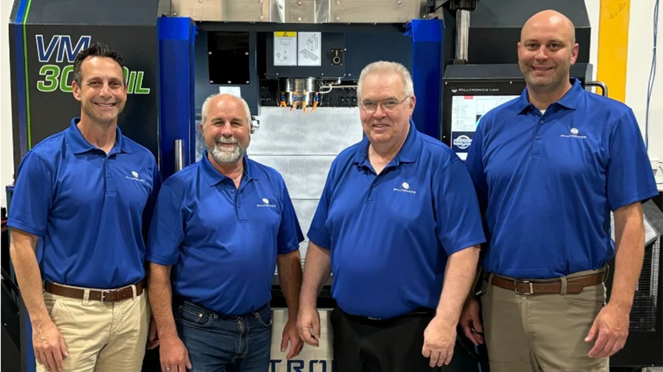 Ryan Delahanty (far left), Don Hammer (middle left), Brian Starnes (middle right) and Steve Schermann (far right) pose for a photo together at the Milltronics headquarters in Indianapolis, Indiana