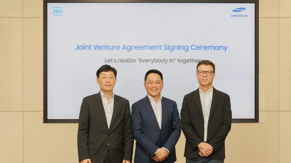 Executives from Samsung SDI and GM stand in front of a screen that reads Joint Venture Agreement Signing Ceremony