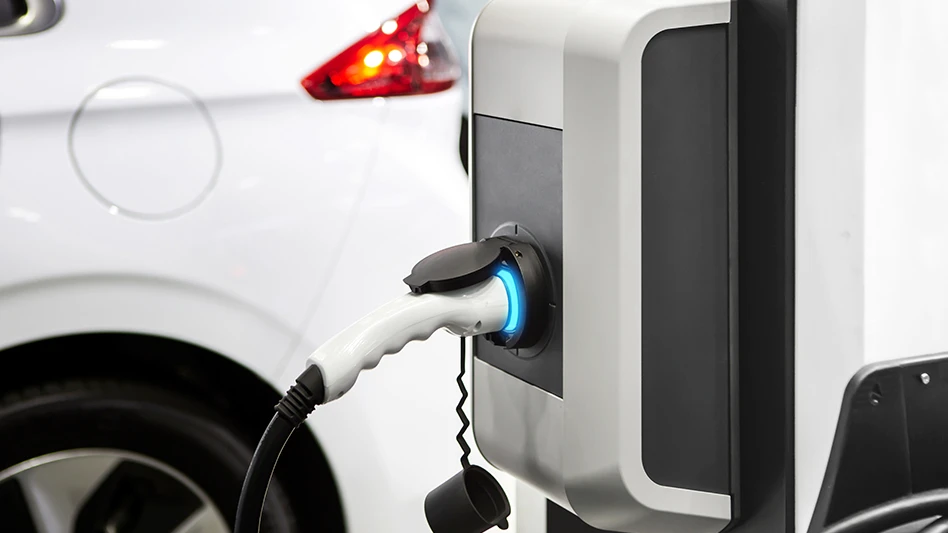 An electric car charger at a charging station