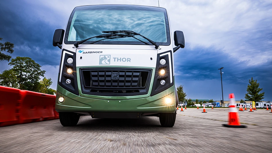 The front of a motorhome with logos from THOR Industries and Harbinger on it
