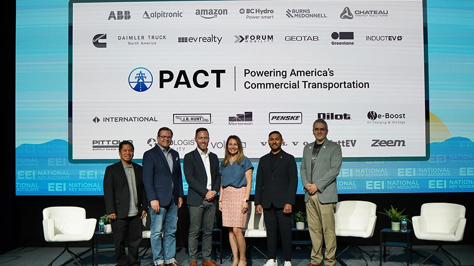 A group of people stand in front of a screen displaying the text PACT - Powering America's Commercial Transportation along with several business logos