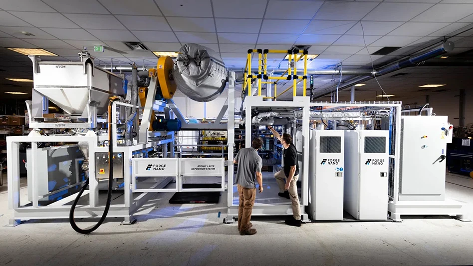 A person points at something in a factory while standing next to another person.