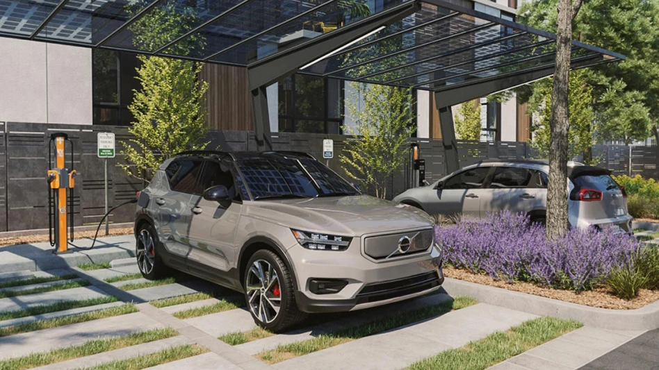 A vehicle in front of a building with a charger