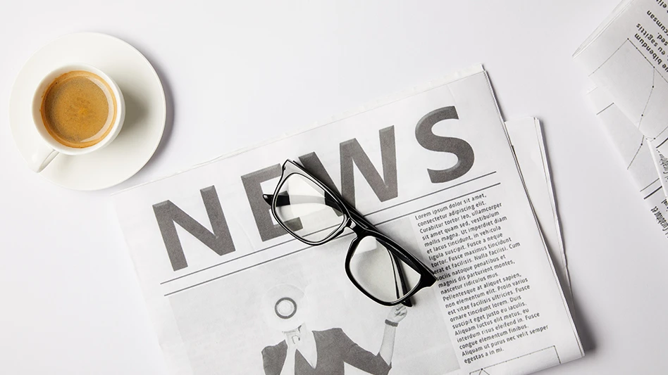 A newspaper and a cup of coffee