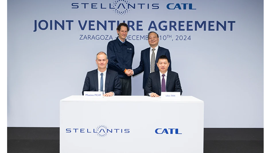 A group of people standing behind a table