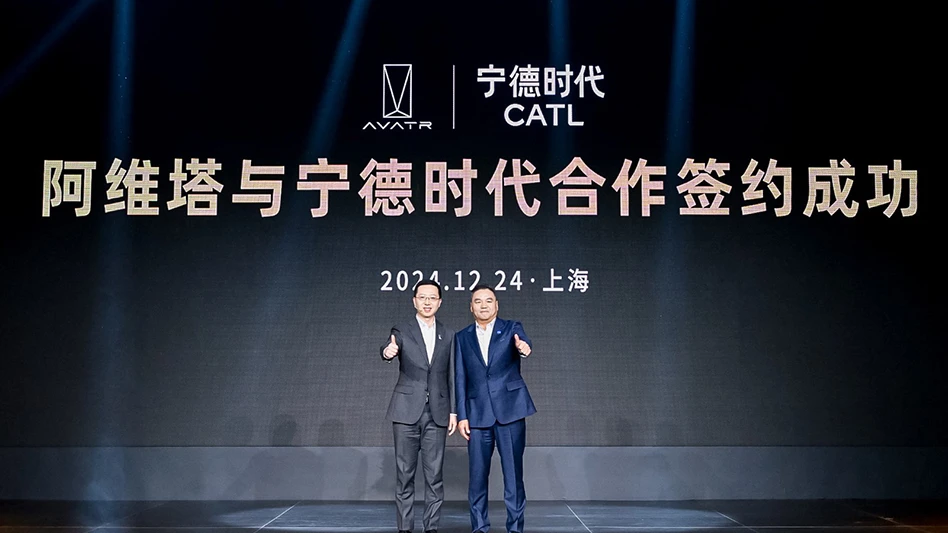 Two people stand in front of a screen