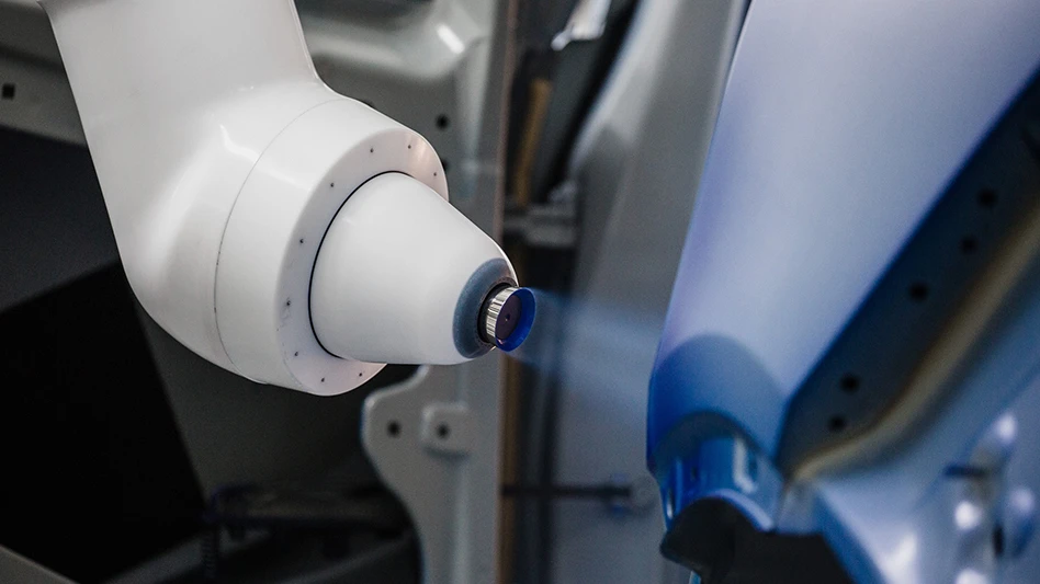 A robot applies paint to a surface