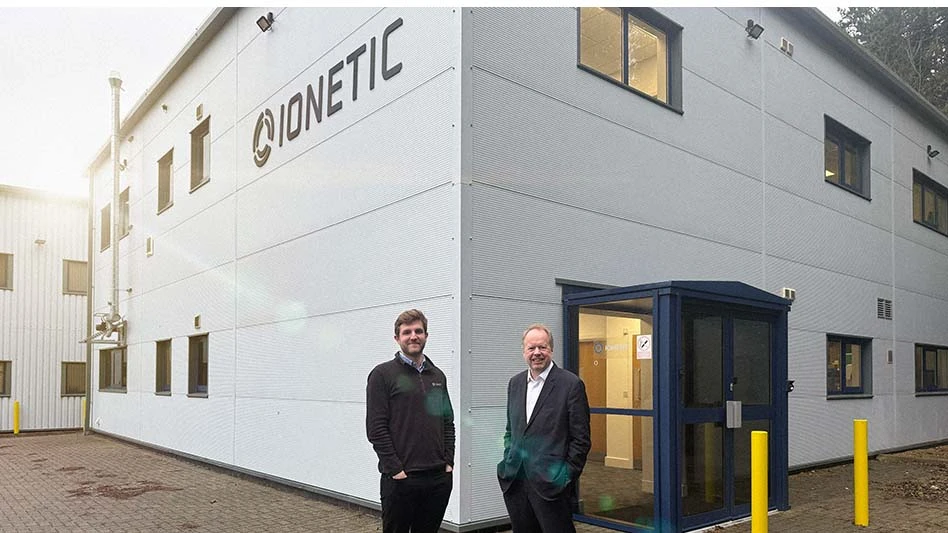 Two people standing in front of a building