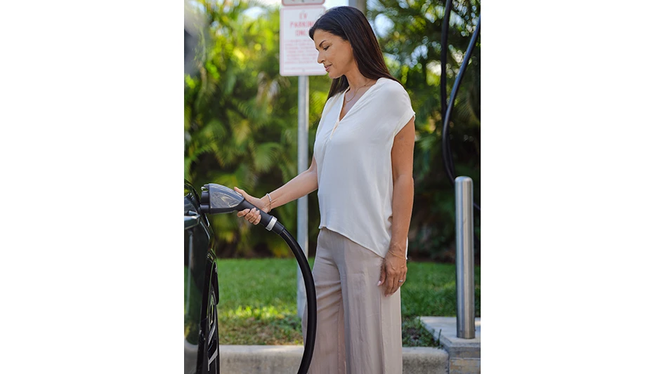A person charging an electric vehicle