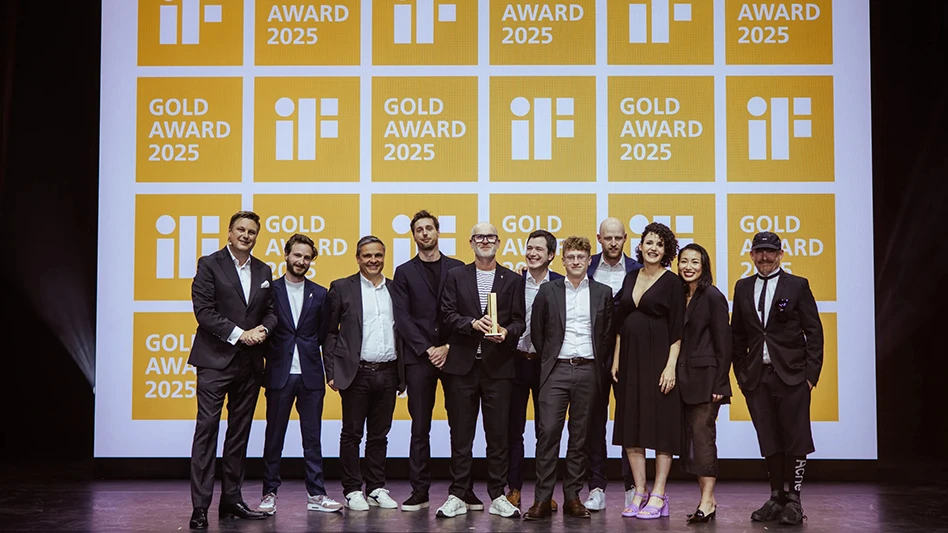 Several people stand on a stage with an award