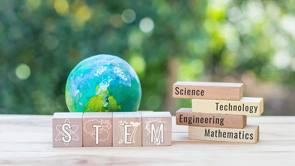 The letters STEM on wooden blocks near a globe