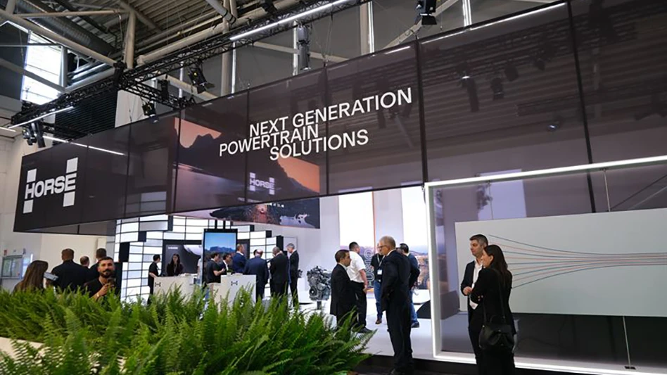 People standing under a sign reading next generation powertrain solutions